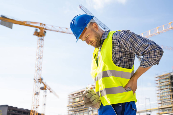Engineer With Back Pain Injury After Accident At Construction Site - Φωτογραφία, εικόνα