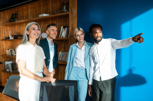 cinematic image of a multiethnic business team. Group of employees working together on a project in the office - Foto, afbeelding
