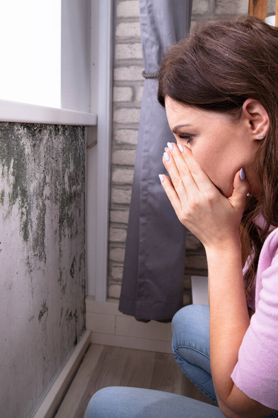 Mold Damage On House Wall. Woman Looking At Wet Moisture - 写真・画像