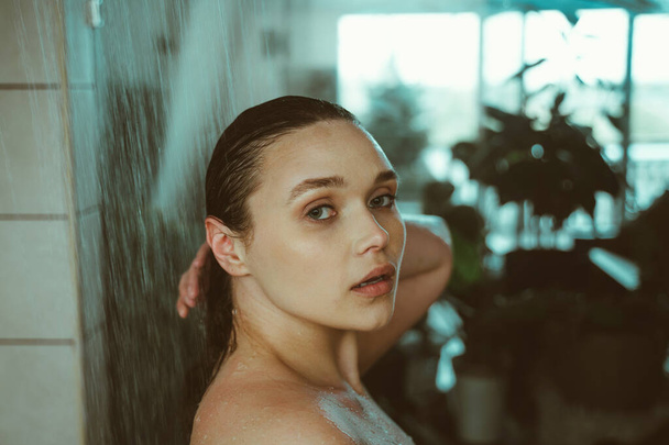 lifestyle moments of a young woman at home. Woman taking a shower in the morning - Valokuva, kuva