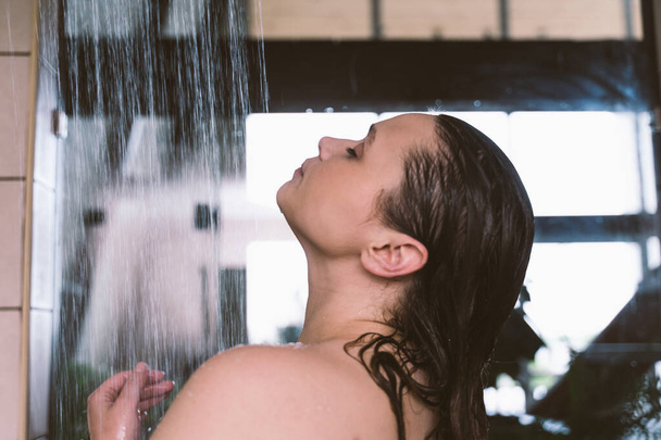 lifestyle moments of a young woman at home. Woman taking a shower in the morning - Photo, image