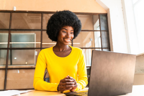 beautiful young woman with the afro haircut working in the office - Photo, Image