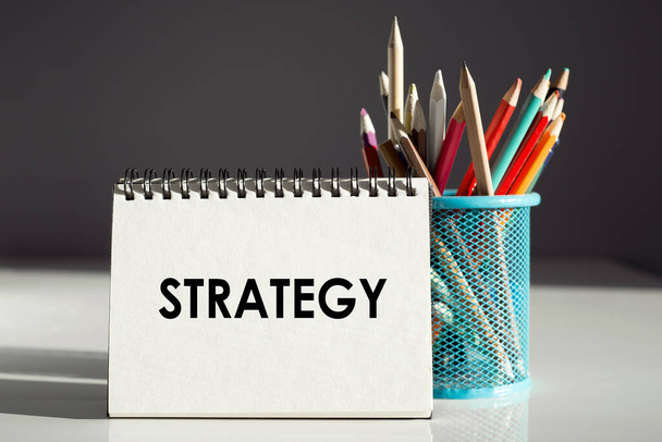 STRATEGY - inscription on a notebook with colored pencils. - 写真・画像