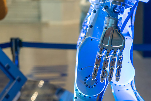 Closeup of metal robot hand. Concept of modern technology. Blue tone - 写真・画像