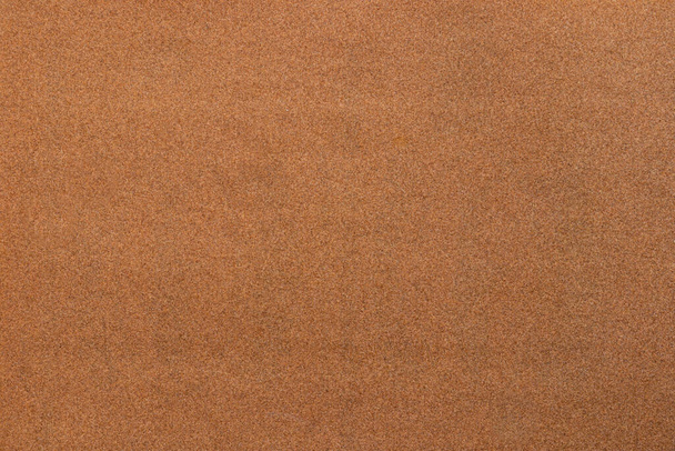 Csiszolópapír textúra háttér, ahol láthatjuk a vörös-barna homokszem mintát a csiszolópapír, alkalmas háttér beillesztésére szöveg. Fénymásolási hely a tervezők számára a csiszolópapírhoz. - Fotó, kép