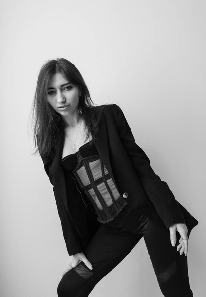 Black and white vogue fashion lifestyle studio portrait of stylish young woman - 写真・画像