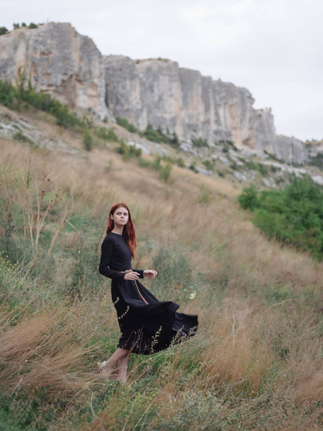woman in black dress and mountains landscape travel - Valokuva, kuva