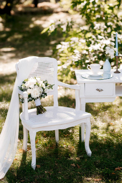 wedding arch with white flowers and chairs - 写真・画像