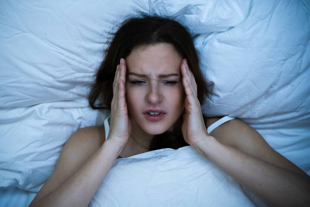 Stressed Woman With Headache Sleeping In Bed With Insomnia - Foto, immagini