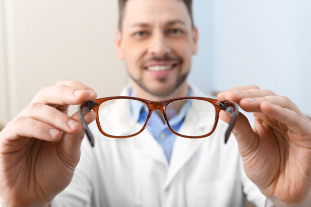 Male ophthalmologist with eyeglasses in clinic - Foto, Imagen