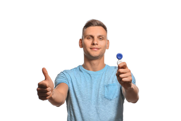 Young man with contact lenses showing OK gesture on white background - Fotoğraf, Görsel