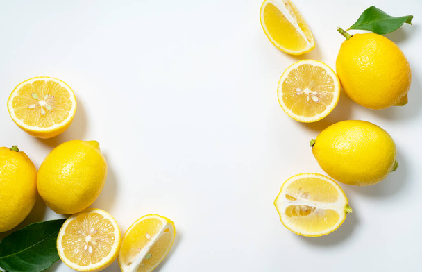 Lemons placed on a white background with copy space and cut in half. View from directly above - Фото, зображення