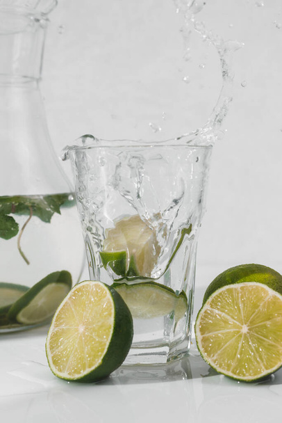 Detox water with lime fruit and mint leaves. Mint fresh homemade lemonade. - Фото, изображение