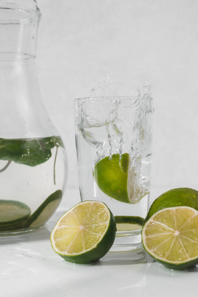 Detox water with lime fruit and mint leaves. Mint fresh homemade lemonade. - Photo, Image