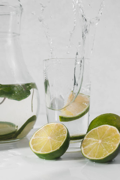 Detox water with lime fruit and mint leaves. Mint fresh homemade lemonade. - 写真・画像