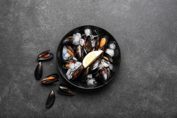 Plate with raw mussels on dark background - Fotó, kép
