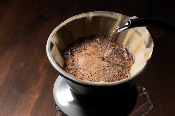 Pour hot water over the coffee powder..Make drip coffee. - Fotó, kép