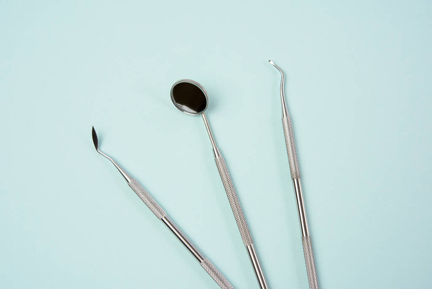metal medical items of the dentist on a blue background, flat lay - Photo, Image