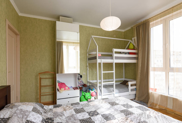 Interior of an adult bedroom, in the room there is a children's bunk bed - Photo, Image