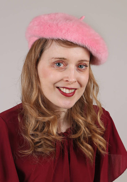 Young beautiful woman with blonde hair curls and blue eyes wearing pink fluffy beret hat - Φωτογραφία, εικόνα