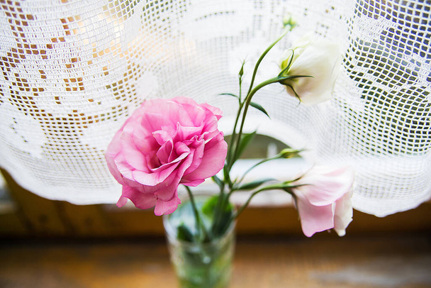 beautiful bouquet of pink and white flowers are on the windowsill - Photo, Image