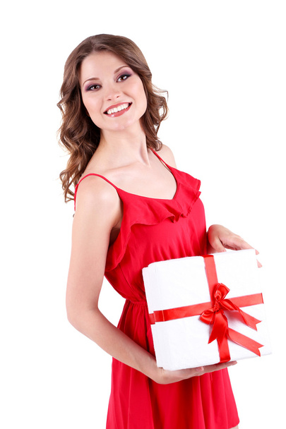 Beautiful young girl in red dress with gift isolated on white - Fotó, kép