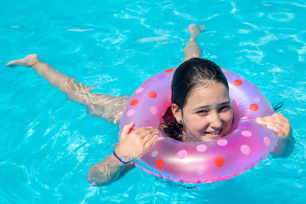 little girl in the pool with a toy - Foto, immagini