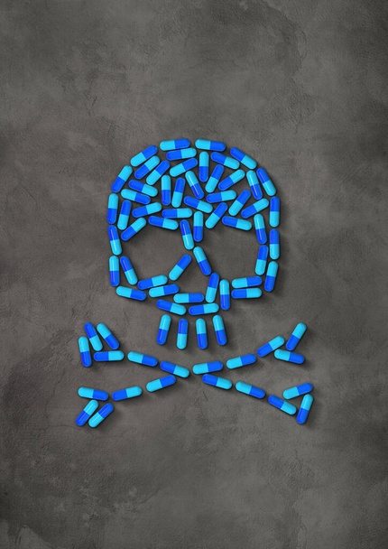 Skull made of blue capsule pills isolated on dark concrete background. 3D illustration - Fotó, kép