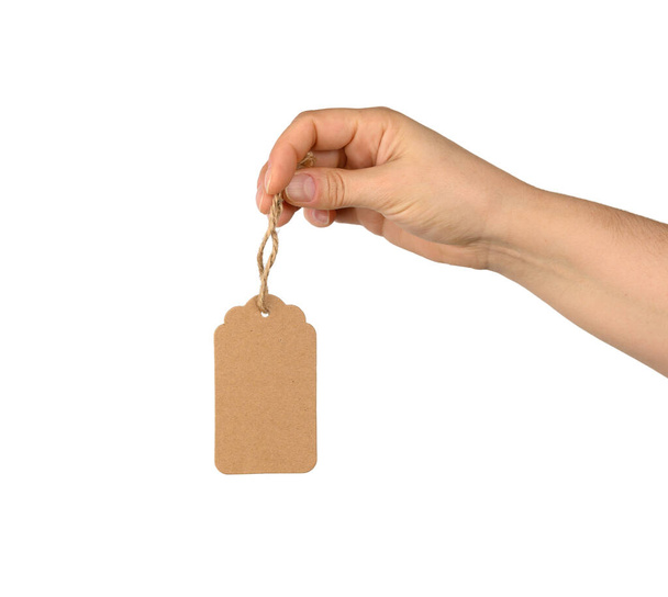 hand hold blank brown rectangular brown paper tag on a rope isolated on white background, template for price, discount - Foto, Imagem