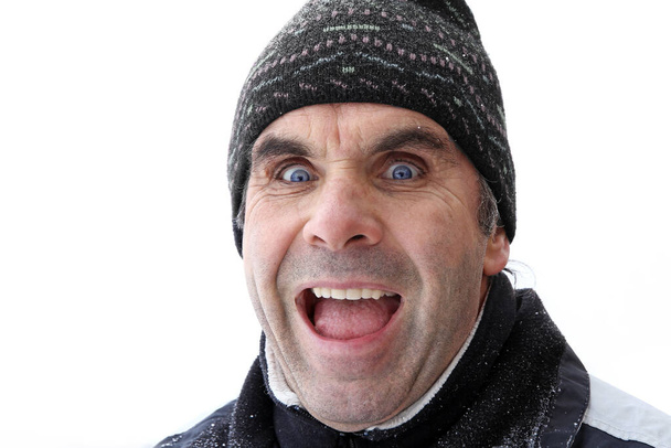 An older man with cap makes a surprised-joyful face - Fotó, kép