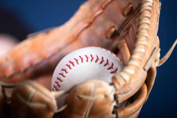 baseball ball and glove on wooden background - Photo, image