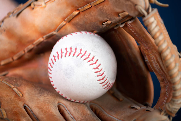 baseball glove and ball on wooden background - Фото, изображение