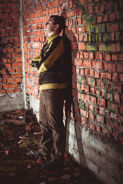 Man leaning on a brick wal - Zdjęcie, obraz