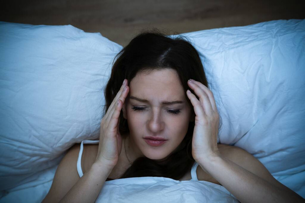 Stressed Woman With Headache Sleeping In Bed With Insomnia - Zdjęcie, obraz