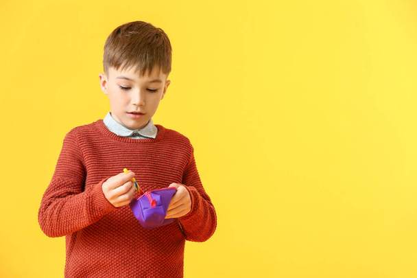 Little boy with pencil case and pen on color background - Fotografie, Obrázek