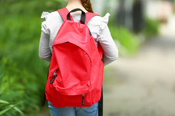 Little schoolgirl with backpack outdoors - Foto, imagen