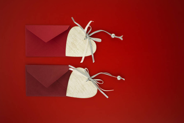 origami paper envelope with red ribbon on a pink background - Φωτογραφία, εικόνα