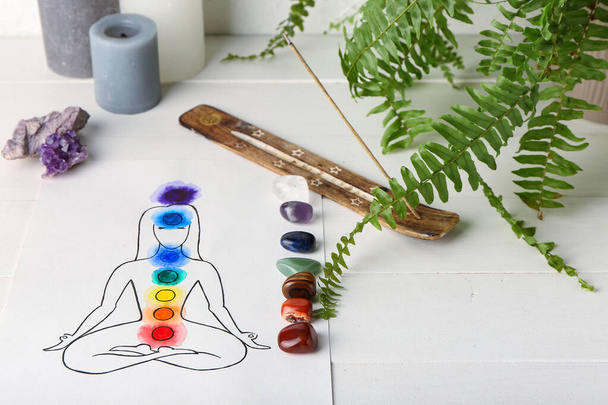 Drawing of human, set of chakra stones and incense on white background - Foto, Bild