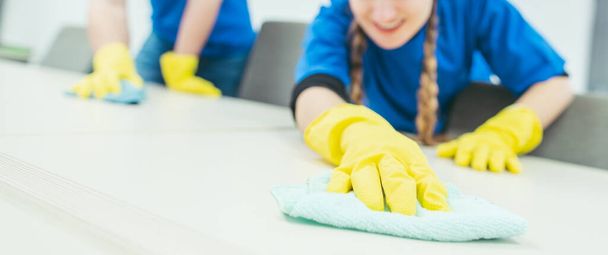 Close-up of cleaning team working in an office, banner cut - Foto, afbeelding