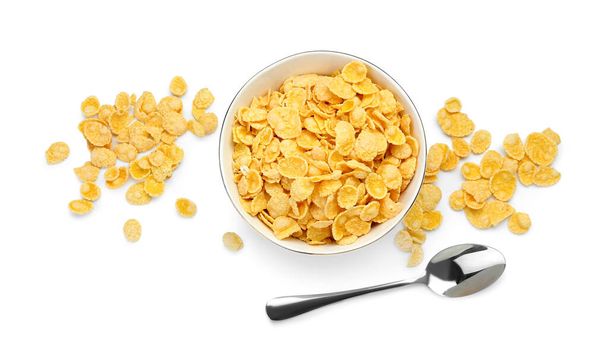 Bowl with tasty cornflakes on white background - Photo, Image