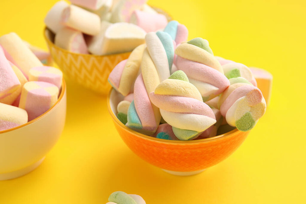 Bowls with tasty marshmallows on color background, closeup - Photo, Image