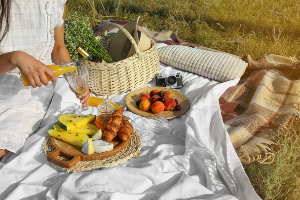 Young woman having picnic outdoors, closeup - Fotoğraf, Görsel