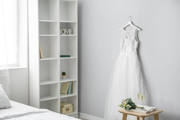 Interior of bedroom with beautiful wedding dress prepared for ceremony - Photo, Image