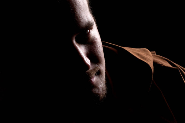 close-up portrait of a man with a beard on black background - Fotografie, Obrázek