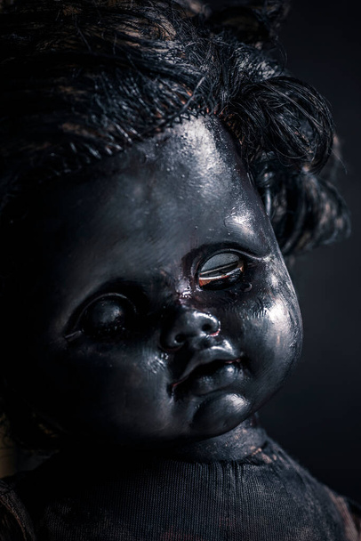 portrait of a young woman with a black face and a mask on a dark background - Foto, Imagem