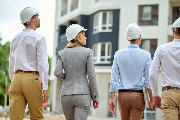 Four people carrying out a construction site inspection - Foto, immagini