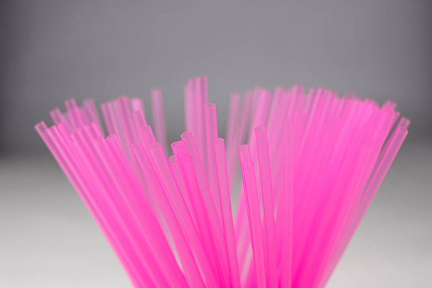 Pink plastic straws for use in soft drinks, juices, and alcoholic combinations - Φωτογραφία, εικόνα