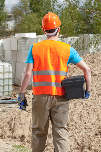 Blue-collar worker with toolbox and grout float - Foto, afbeelding