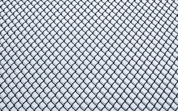 Frozen small chain-link fence pattern. - Photo, Image