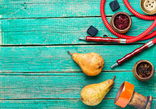 Oriental smoking shisha with tobacco.Fruit tobacco with pear flavor.Copy space - Zdjęcie, obraz